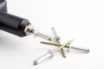 black rivet pliers and rivet on white background