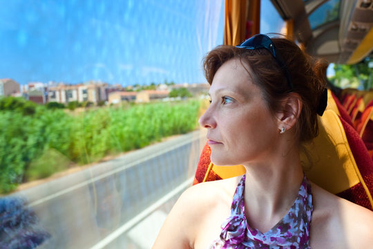  woman in the bus looks out of the window