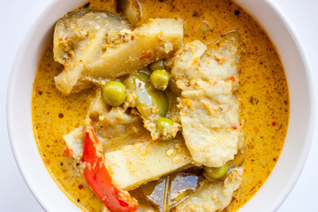 Pork curry in white bowl.