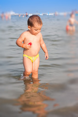 Happy Baby playing in the water at the beach