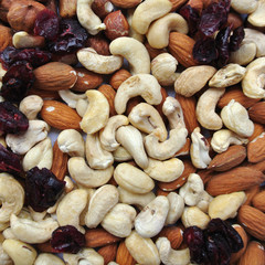 Close-up of a pile of various nuts - almonds, cashews and hazelnuts, and dried cranberries. Concept of clean/healthy eating; organic, unprocessed food; paleo diet. - 87327039