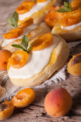 Apricot pastries with soft cream and mint close-up vertical
