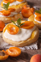 Apricot puff pastry with cream close-up. vertical
