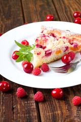 Fruit pie on white plate with berries