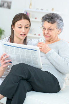 Reading a newspaper with an old lady