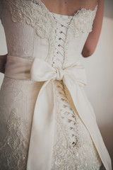 Beautiful luxury lace wedding dress and white bow 