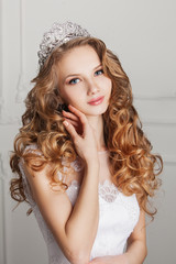 Portrait of beautiful bride with crown on white background. 