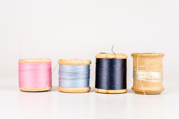 Vintage wooden thread spool with isolated on white background