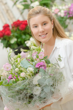 Florist holding a flower arrangement
