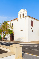 White church with inscription on wall "Plaza de Los Remedios" meaning "Square of remedy" in Yaiza village, Lanzarote island, Spain