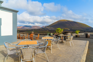 Tables with chairs on terrace of winery in La Geria, Lanzarote, Canary Islands, Spain