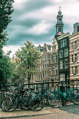Obraz na płótnie Canvas Amsterdam canal and bridge with bikes, Holland