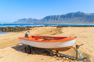 Selbstklebende Fototapeten Fishing boat on Famara beach, Lanzarote, Canary Islands, Spain © pkazmierczak