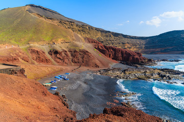 Beach with fishing boats on shore in El Golfo, Lanzarote, Canary Islands, Spain