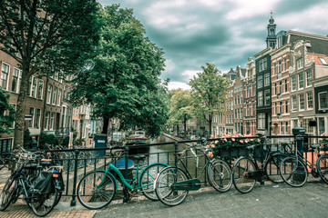 Fototapeta premium Amsterdam canal and bridge with bikes, Holland