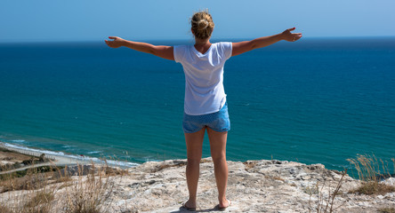 Woman relaxing with closed eyes, hands spread