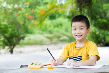boy use pencil writing on notebook for writing book