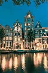 Fototapeta na wymiar Night Amsterdam canal with dutch houses
