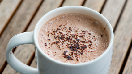 Hot chocolate in a white cup on table