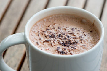 Hot chocolate in a white cup on table