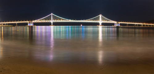 Illuminated Gwangalli Bridge in the late evening time. Busan city