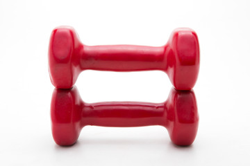 Red rubber dumbbell on white background.