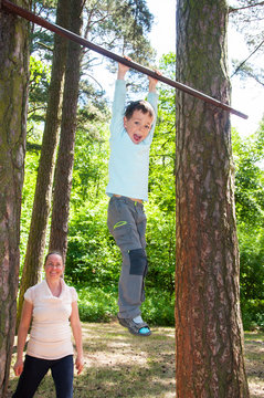  Boy With Mother Doing Pull Ups In Park