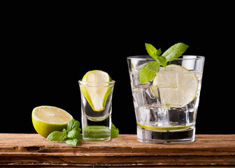 alcoholic drink with lemon and ice on a old wooden table