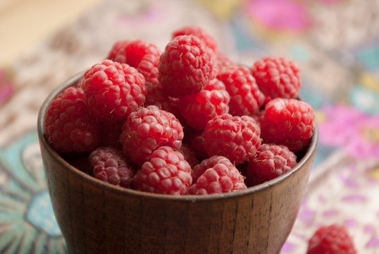 raspberries in wooden bowl