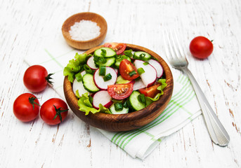 Spring salad with tomato, cucumbers and radish