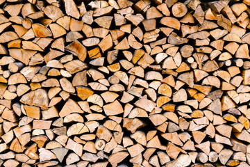 Minced wooden logs stacked in the woodpile
