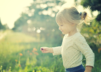 Cute little girl in the sunshine. Back lighting. © itsmejust