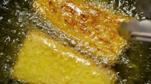 Fish corners sizzling in a cauldron of hot oil.