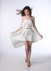 Portrait of a beautiful girl in a little white dress