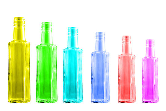 Colored bottles standing in a row on a white background.