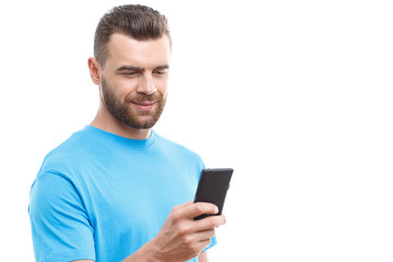 Handsome man with beard holding mobile phone 