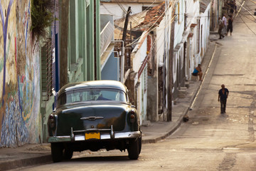 A classic car in a street in Santiago de Cuba