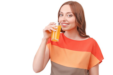 Pretty red-haired woman drinking juice 