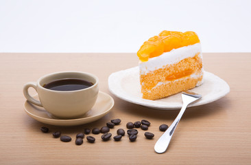cup of coffee and delicious cake on white background