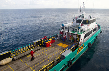 Rig workers are transported on a vessel to offshore rigs in The South China Sea