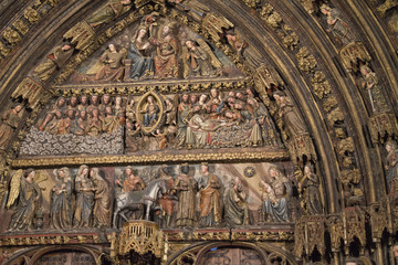 Fototapeta na wymiar Wood carved polychrome portal from the 14th century in the Church of Santa Maria de los Reyes(Saint Mary of the Kings).Laguardia,Spain