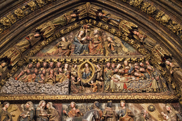 Detail of the wood carved polychrome portal from the 14th century in the Church of Santa Maria de...