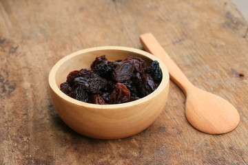 Heap of raisins on wood background
