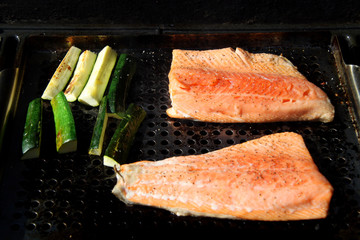 salmon steelhead fillets on the grill with zucchini vegetable