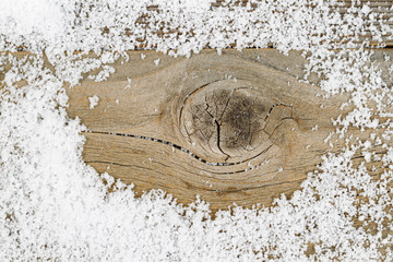 Close up of snow on rustic wood