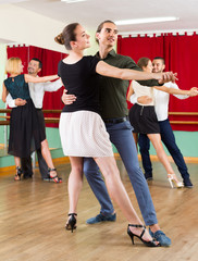 men and women enjoying of tango in class