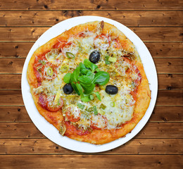 Italian pizza with olives on wooden table