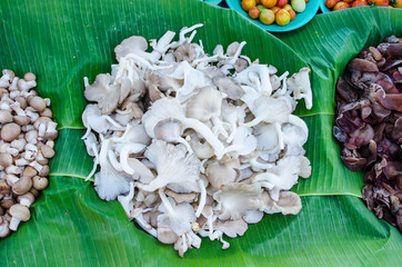 pile of sajor-caju mushroom in wicker basket for sale in local market in thailand