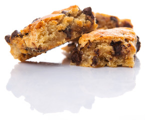 Sweet brownie dessert bar with chocolate chips over white background