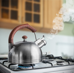 kettle boiling on a gas stove in the kitchen